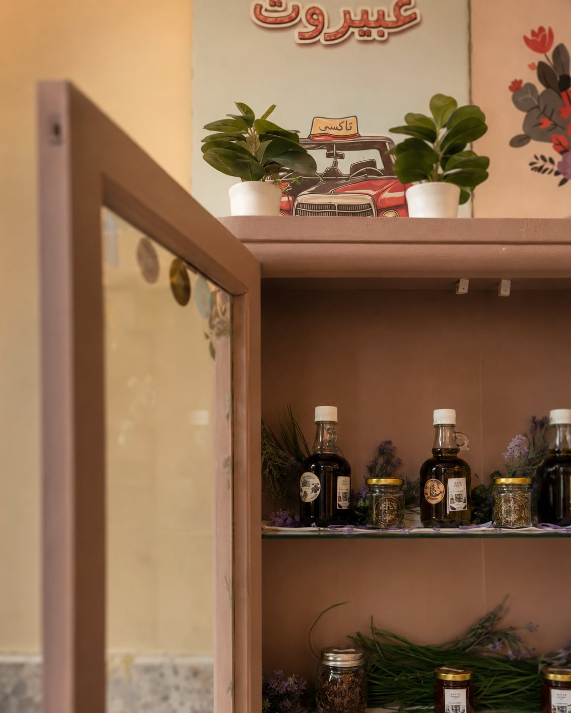 Bayt&eacute; Boutique &mdash; the open cabinet seen from the side, JARN bottles and jars on the shelves