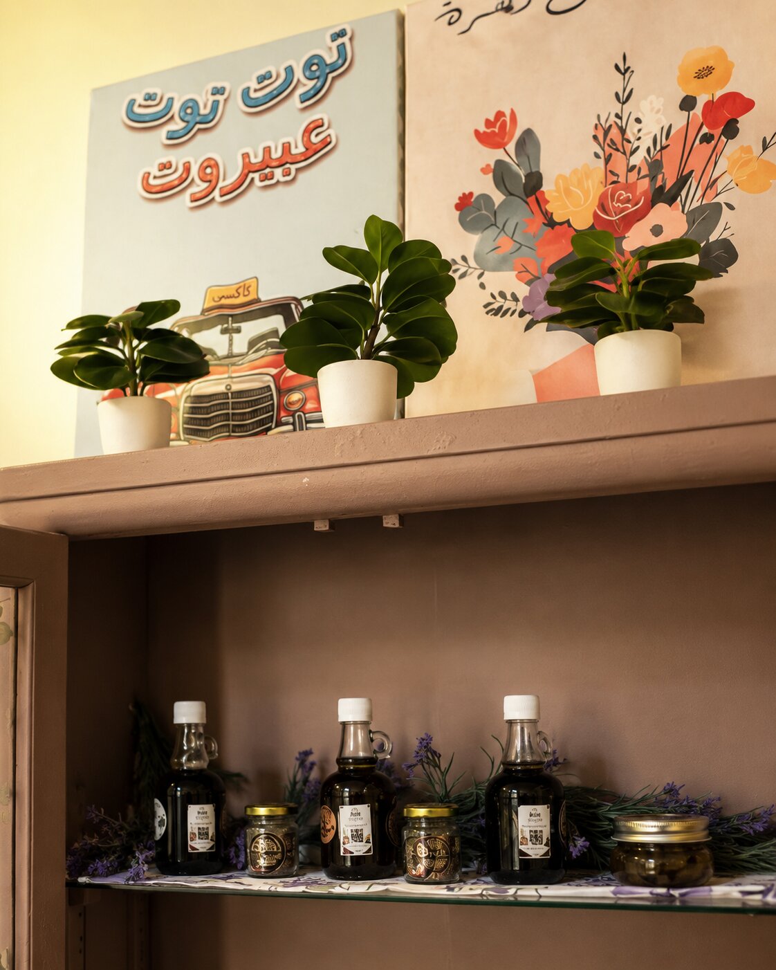 Top of the cabinet with Arabic art posters and small plants