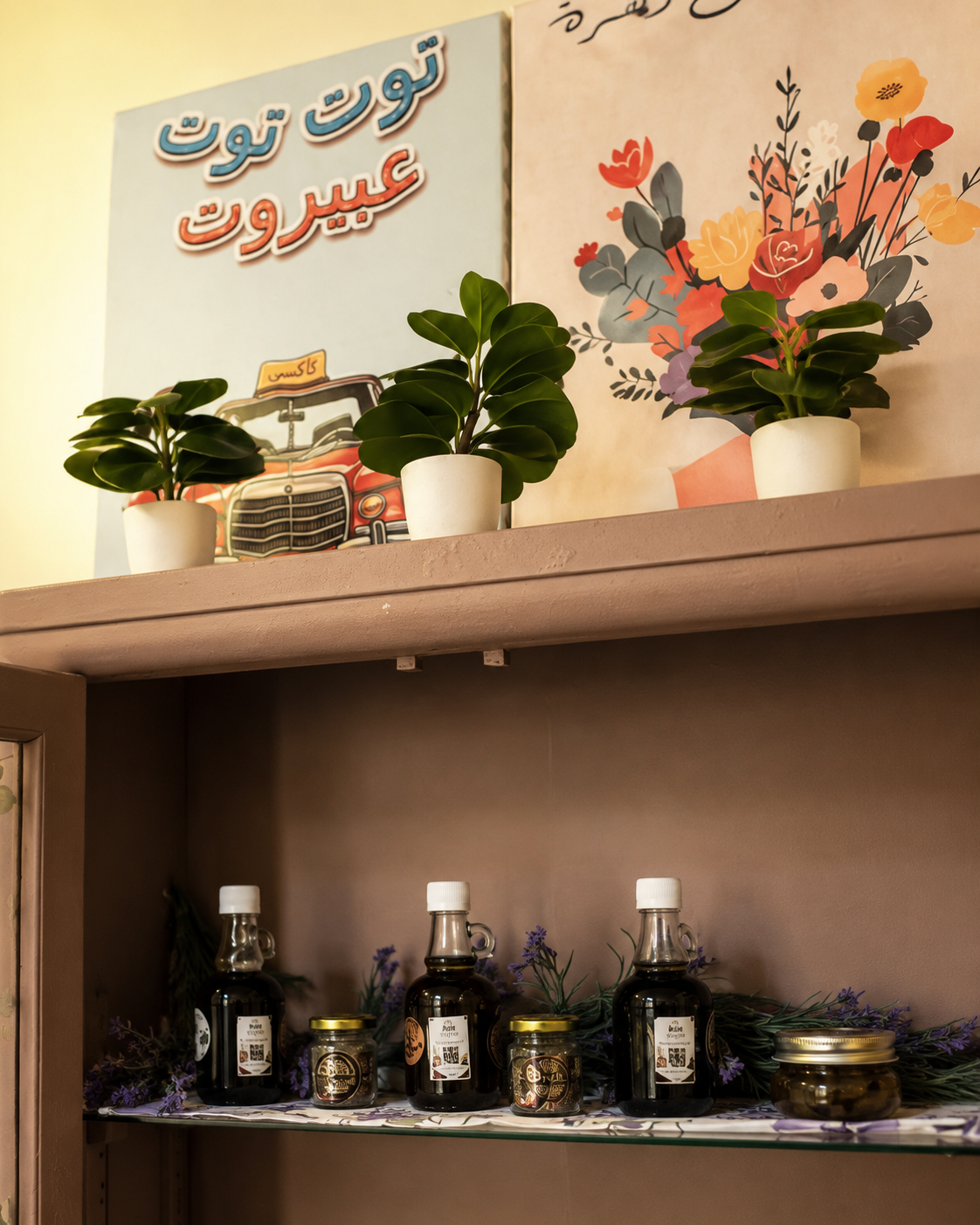 Top of the cabinet with Arabic art posters and small plants